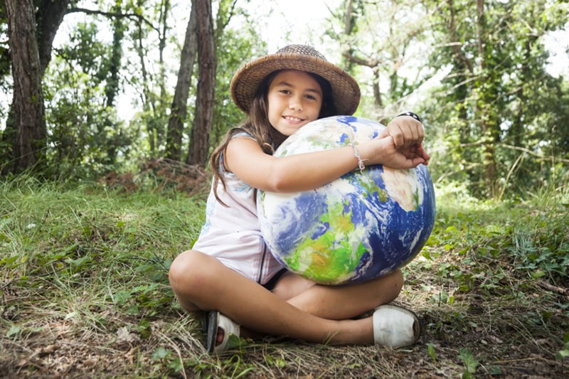 Understanding Geothermal Heat Pump Costs in Phoenix. I love my planet: Young scout girl embracing world globe.