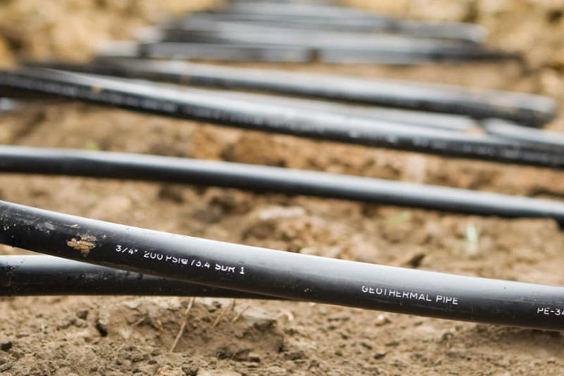 Understanding Geothermal Heat Pump Costs. Photo of Geothermal coiled in an underground trench.